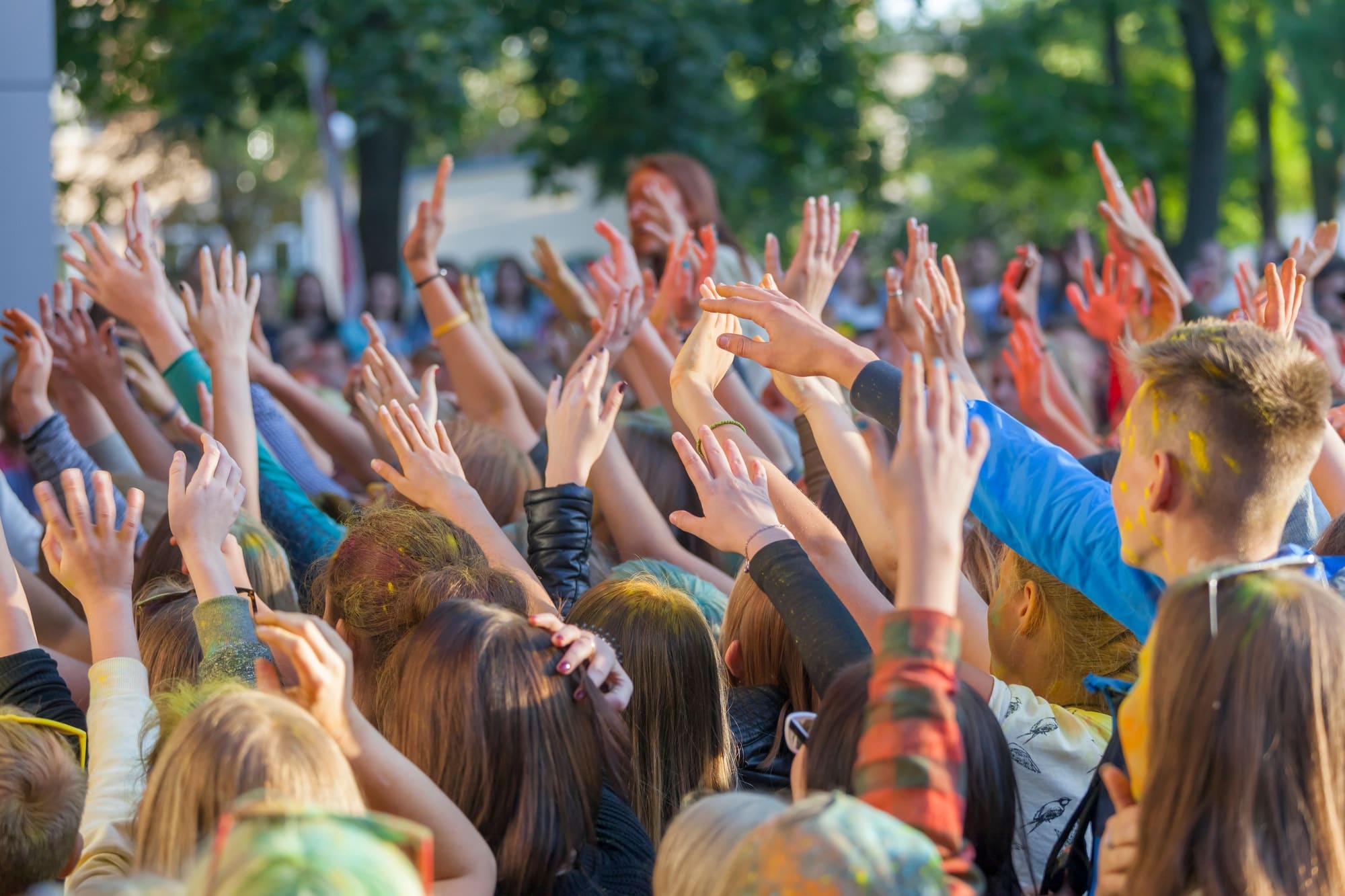 Teenagers at the musical festival, hands in the air